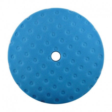 Blue polishing pad with a white center on a white background