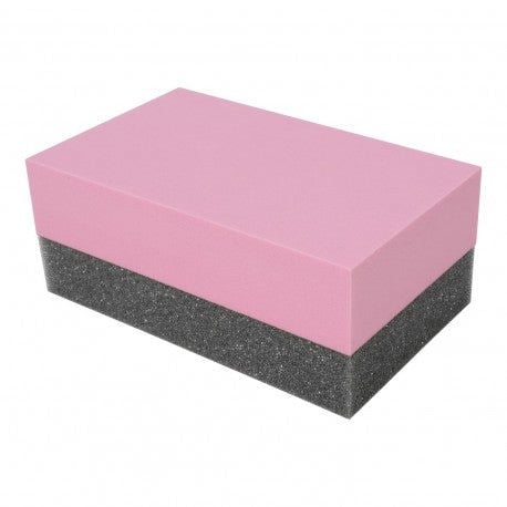Pink and black sanding block on a white background