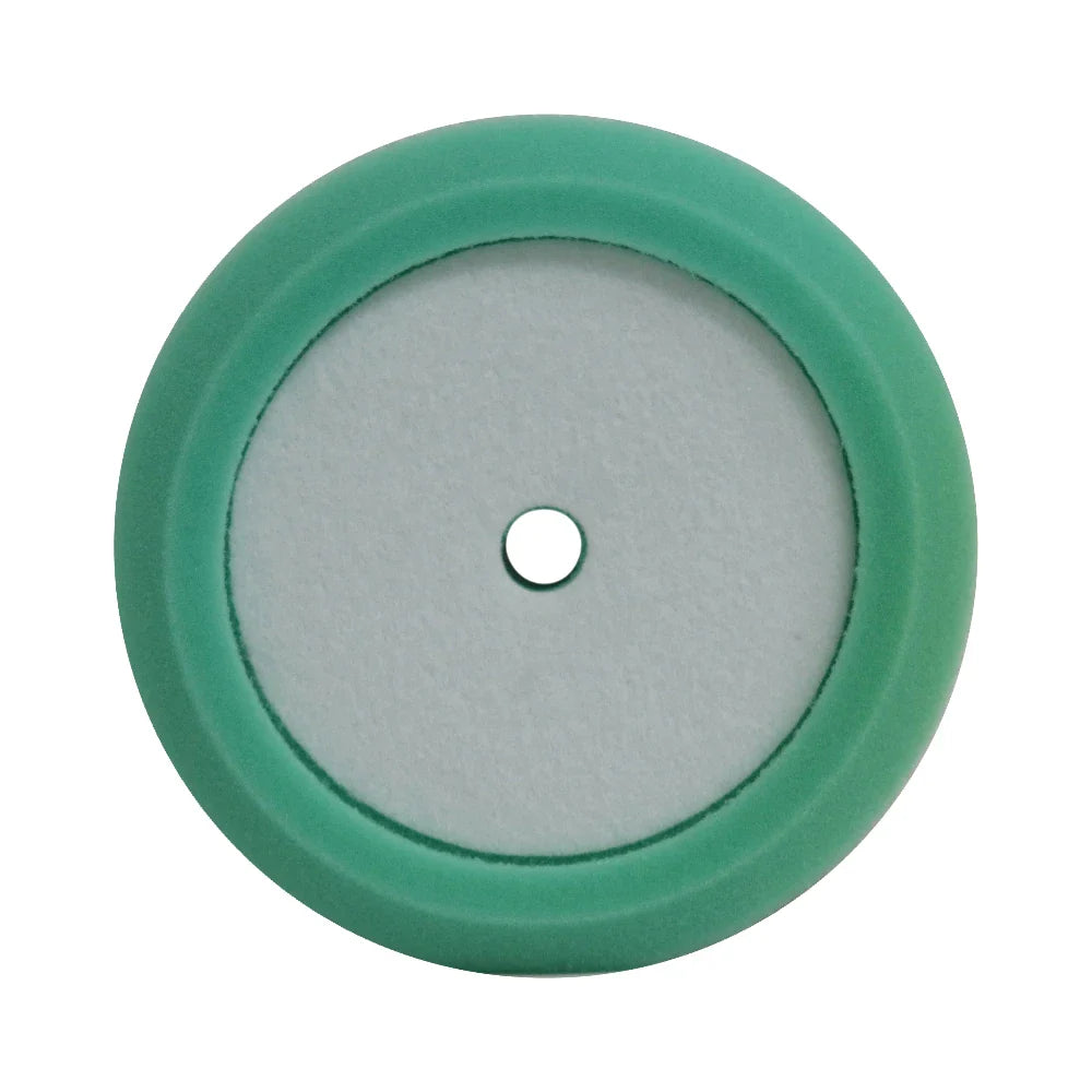 A circular green and white foam pad with a central hole for attachment.