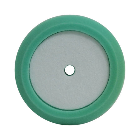 A circular green and white foam pad with a central hole for attachment.