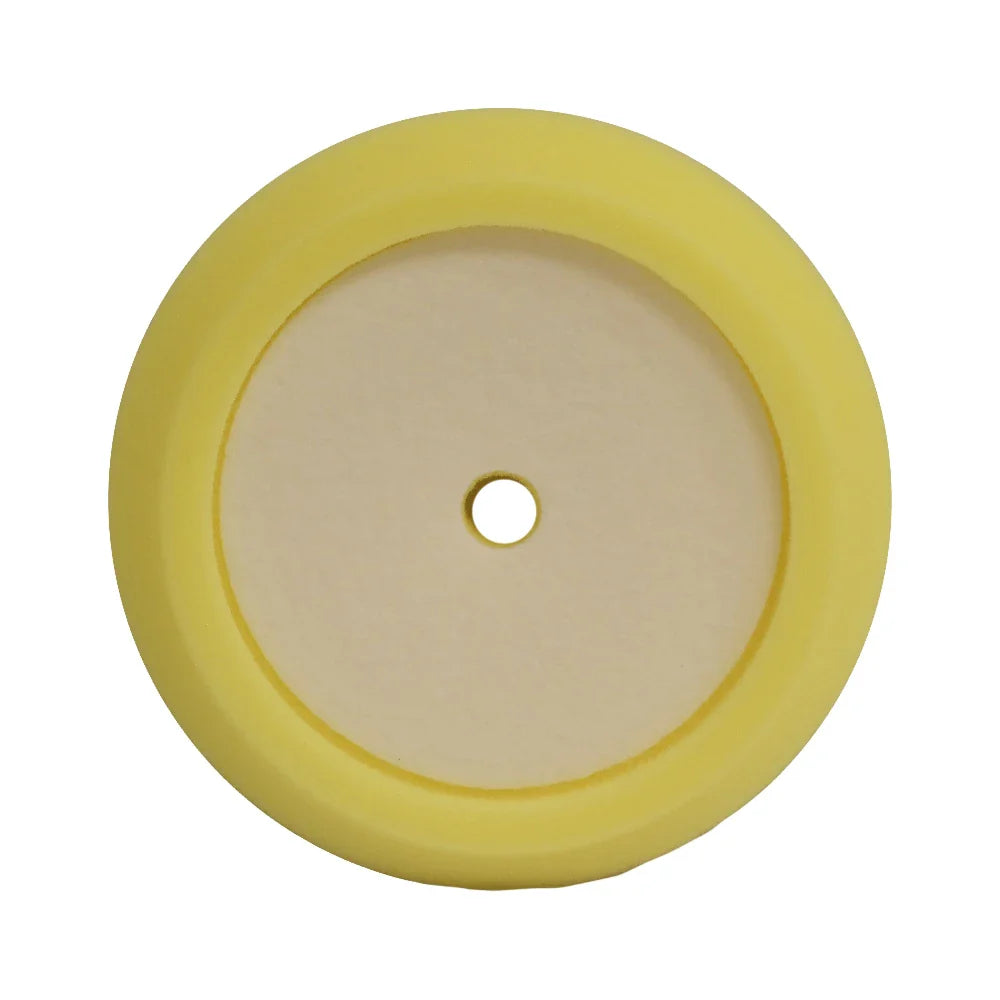 A circular yellow foam pad with a medium-cut design, used for polishing and buffing vehicle surfaces.