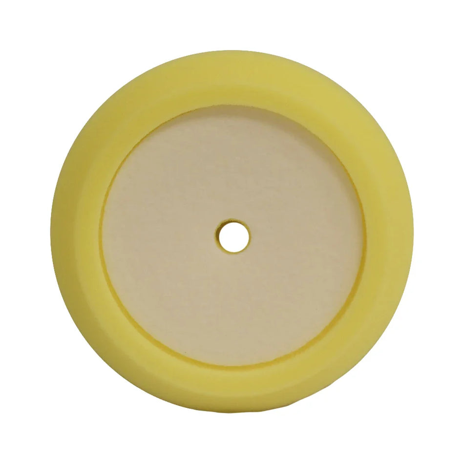 A circular yellow foam pad with a medium-cut design, used for polishing and buffing vehicle surfaces.