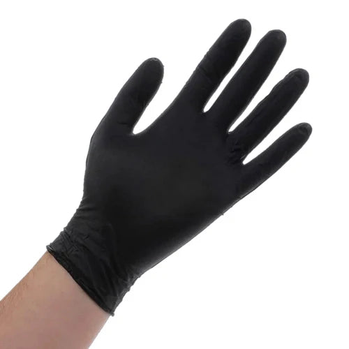 A single black powder-free nitrile glove on a human hand against a white background.