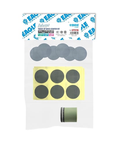 Packaged touch-up paint kit with circular patches and a roll of tape on a white background.